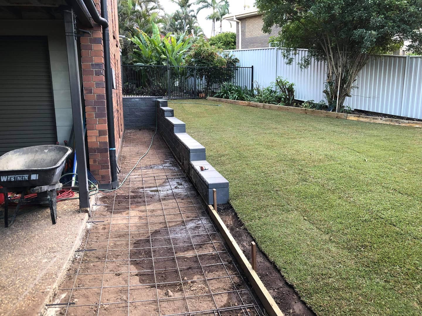 Retaining, turfing, fencing, concreting and new side entrance